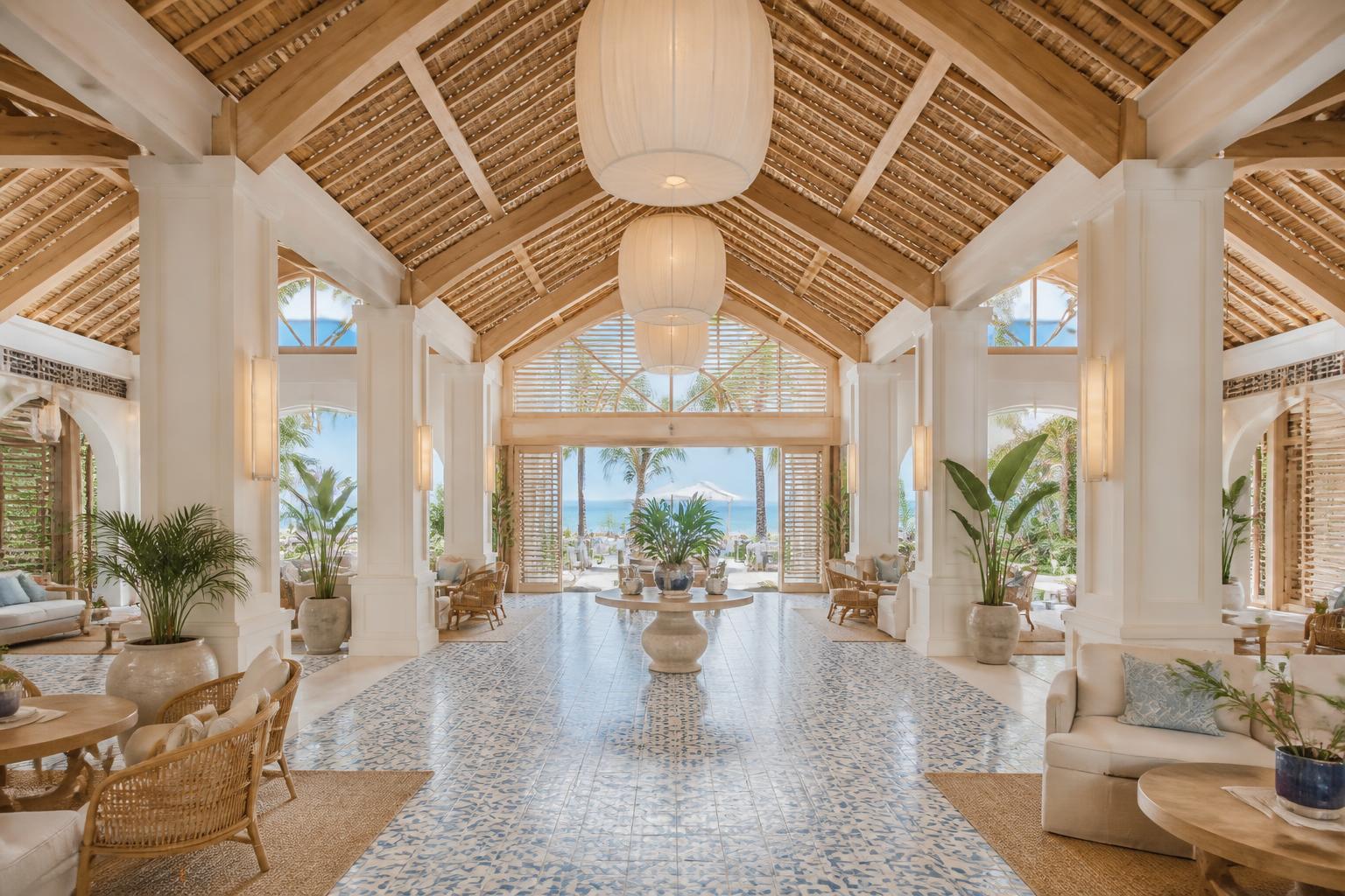 The Sandy Hotel open-air lobby with timber roof, lantern pendants and ocean view